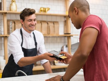 People interacting over counter.